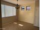 Bright dining room with large windows, chandelier, and neutral colored walls at 7422 W Superior Ave, Phoenix, AZ 85043