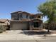 Two-story home featuring a symmetrical facade, a two-car garage, and low-maintenance landscaping at 7422 W Superior Ave, Phoenix, AZ 85043
