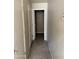 Hallway features neutral tones, tile flooring, and multiple doors leading to various rooms at 7422 W Superior Ave, Phoenix, AZ 85043