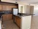 Spacious kitchen featuring wooden cabinets, dark countertops and stainless steel appliances at 7422 W Superior Ave, Phoenix, AZ 85043