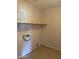 Dedicated laundry room with a tile floor and a shelf at 7422 W Superior Ave, Phoenix, AZ 85043