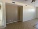 Neutral-toned living room with tile flooring, built in shelf and a view of the staircase at 7422 W Superior Ave, Phoenix, AZ 85043