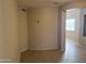 Neutral-toned room with tile flooring, an air vent and a view of the entry at 7422 W Superior Ave, Phoenix, AZ 85043