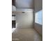 Bright living room with a large window and high ceilings with neutral paint and tile flooring at 7422 W Superior Ave, Phoenix, AZ 85043