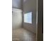 Bright living room with a large window and high ceilings with neutral paint and tile flooring at 7422 W Superior Ave, Phoenix, AZ 85043