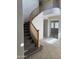 Open staircase featuring a wooden railing and carpeted stairs leading to the upper level at 7422 W Superior Ave, Phoenix, AZ 85043