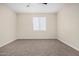 A bedroom featuring neutral walls, ceiling fan, window, and carpet at 802 W Buist Ave, Phoenix, AZ 85041