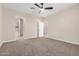 Neutral bedroom featuring ceiling fan, carpet and an ensuite bathroom at 802 W Buist Ave, Phoenix, AZ 85041