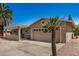 Tan stucco home featuring desert landscaping, a two-car garage, and a covered front porch at 871 Leisure World --, Mesa, AZ 85206