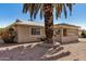 Side view of a desert home with neutral stucco, decorative rock landscaping and mature palm tree at 871 Leisure World --, Mesa, AZ 85206