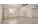 Bright living room featuring wood-look flooring, ceiling fan, and a large window at 871 Leisure World --, Mesa, AZ 85206