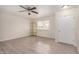 Bright living room featuring wood-look flooring, ceiling fan, and a large window at 871 Leisure World --, Mesa, AZ 85206