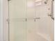 Shower featuring glass doors, shower head, grab bar, and bright lighting at 871 Leisure World --, Mesa, AZ 85206