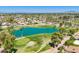 An aerial view of a vibrant golf course community with mature landscaping and a serene pond at 9339 E Sun Lakes N Blvd, Sun Lakes, AZ 85248