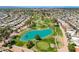 Aerial view of a community featuring a golf course, pond, and mature landscaping at 9339 E Sun Lakes N Blvd, Sun Lakes, AZ 85248