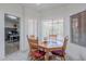 Bright dining space with a wood table and chairs, plus large windows offering plenty of natural light at 9339 E Sun Lakes N Blvd, Sun Lakes, AZ 85248