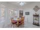 Cozy dining area with a wooden table, cushioned chairs, and natural light from surrounding windows at 9339 E Sun Lakes N Blvd, Sun Lakes, AZ 85248