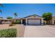 Charming single-story home features a well-manicured front yard and a two-car garage at 9339 E Sun Lakes N Blvd, Sun Lakes, AZ 85248