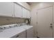 Functional laundry room featuring a washer and dryer, and ample storage at 9339 E Sun Lakes N Blvd, Sun Lakes, AZ 85248