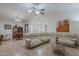 Spacious living room featuring tile floors, a ceiling fan, and a comfortable white leather sectional sofa at 9339 E Sun Lakes N Blvd, Sun Lakes, AZ 85248