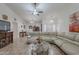 Bright living room features neutral tones, tile flooring, and a comfortable curved sectional sofa at 9339 E Sun Lakes N Blvd, Sun Lakes, AZ 85248
