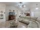 Bright living room features neutral tones, tile flooring, and a comfortable curved sectional sofa at 9339 E Sun Lakes N Blvd, Sun Lakes, AZ 85248