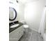 Bathroom featuring a granite sink top, oval mirror, and tiled floors at 9625 W Mountain View Rd # B, Peoria, AZ 85345