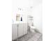 Well-lit bathroom with white vanity, toilet, shelving, and tile floors at 9625 W Mountain View Rd # B, Peoria, AZ 85345