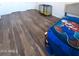 A bedroom with a pet carrier, wood-look floors, and a youthful blanket on the bed at 9625 W Mountain View Rd # B, Peoria, AZ 85345