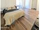 Spacious bedroom with a bed, wood floors, and sliding glass doors to the exterior at 9625 W Mountain View Rd # B, Peoria, AZ 85345