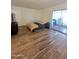 Large bedroom with wood-look flooring and sliding glass doors at 9625 W Mountain View Rd # B, Peoria, AZ 85345