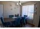 Cozy dining area featuring a rustic table with stylish seating, illuminated by an elegant chandelier and natural light at 9625 W Mountain View Rd # B, Peoria, AZ 85345