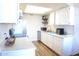 Well-lit kitchen features white cabinets, modern appliances, and ample counter space for meal preparation at 9625 W Mountain View Rd # B, Peoria, AZ 85345