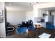 Open floor plan with the dining area flowing seamlessly into the living room and modern kitchen with stainless steel appliances at 9625 W Mountain View Rd # B, Peoria, AZ 85345
