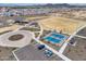 Aerial view showcasing neighborhood recreational area with sports courts, park, parking lot and landscaping at 9723 W Patrick Ln, Peoria, AZ 85383