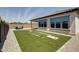 Backyard features turf, patio, and privacy wall, ideal for outdoor entertaining at 9723 W Patrick Ln, Peoria, AZ 85383