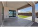 Covered patio with view of artificial grass and area with pavers for outdoor seating at 9723 W Patrick Ln, Peoria, AZ 85383