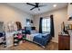 Bedroom with neutral walls, ceiling fan, and a window letting in ample natural light at 9723 W Patrick Ln, Peoria, AZ 85383