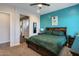 Serene bedroom with turquoise accent wall, plush carpet, and an ensuite bathroom at 9723 W Patrick Ln, Peoria, AZ 85383