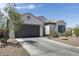 Charming single-story home featuring a well-maintained front yard and a spacious driveway leading to the garage at 9723 W Patrick Ln, Peoria, AZ 85383