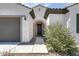 Inviting home entrance with a well-maintained landscape and a dark-colored front door at 9723 W Patrick Ln, Peoria, AZ 85383