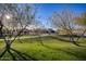 Lush green space with walking path, trees, and bright sunlight, perfect for outdoor enjoyment at 9723 W Patrick Ln, Peoria, AZ 85383