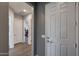 Hallway with views of bedroom and bathroom featuring neutral colors and multiple doors at 9723 W Patrick Ln, Peoria, AZ 85383
