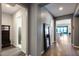 Hallway featuring wood floors, neutral walls, and views into other rooms at 9723 W Patrick Ln, Peoria, AZ 85383