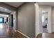 Hallway with wood floors leading into a room with a blue accent wall and lots of natural light at 9723 W Patrick Ln, Peoria, AZ 85383