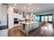 Modern kitchen featuring a large center island, stainless steel appliances, pendant lights and eat-in breakfast nook at 9723 W Patrick Ln, Peoria, AZ 85383