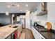 Modern kitchen with stainless steel appliances, granite countertops, and ample storage space at 9723 W Patrick Ln, Peoria, AZ 85383