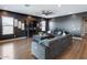 Modern living room with a cozy fireplace, dark walls, wood flooring, and comfortable seating arrangements at 9723 W Patrick Ln, Peoria, AZ 85383