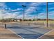 Outdoor pickleball court with lights, fencing and views of the neighborhood at 9723 W Patrick Ln, Peoria, AZ 85383