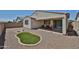 Backyard featuring an artificial turf area and a covered patio with seating at 10739 W Sierra Pinta Dr, Peoria, AZ 85373
